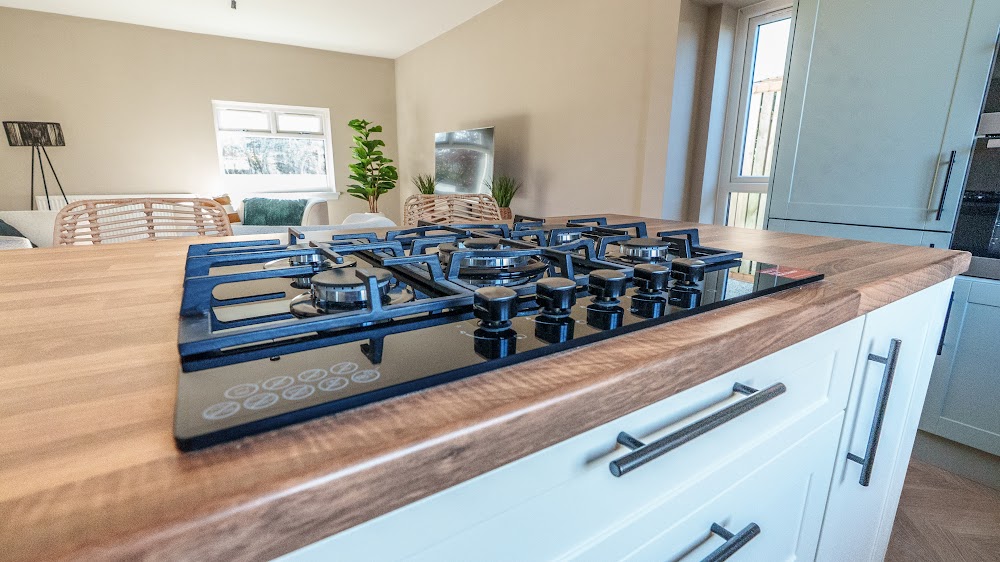 Wood worktop and gas hob detail in a fitted kitchen