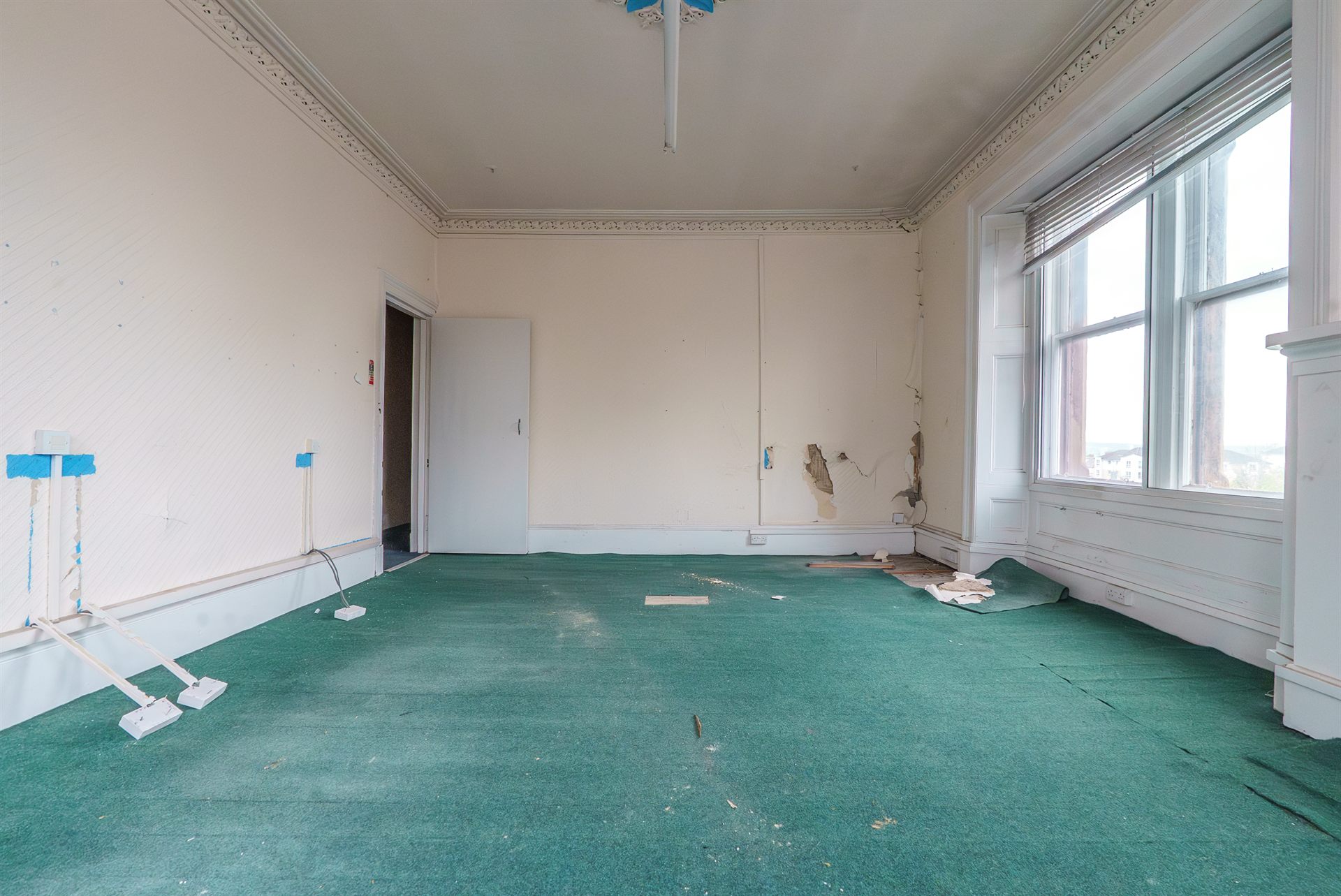 A room in the Motherwell building in run-down, original condition
